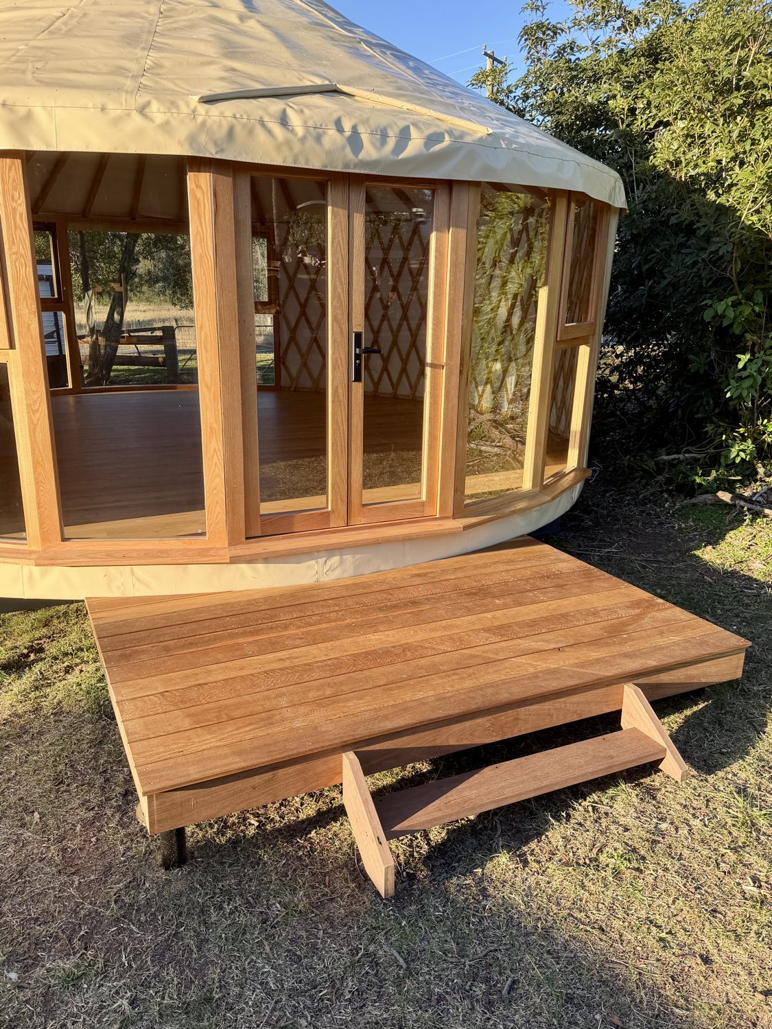 Finished hardwood entry deck built in front of the yurt doors