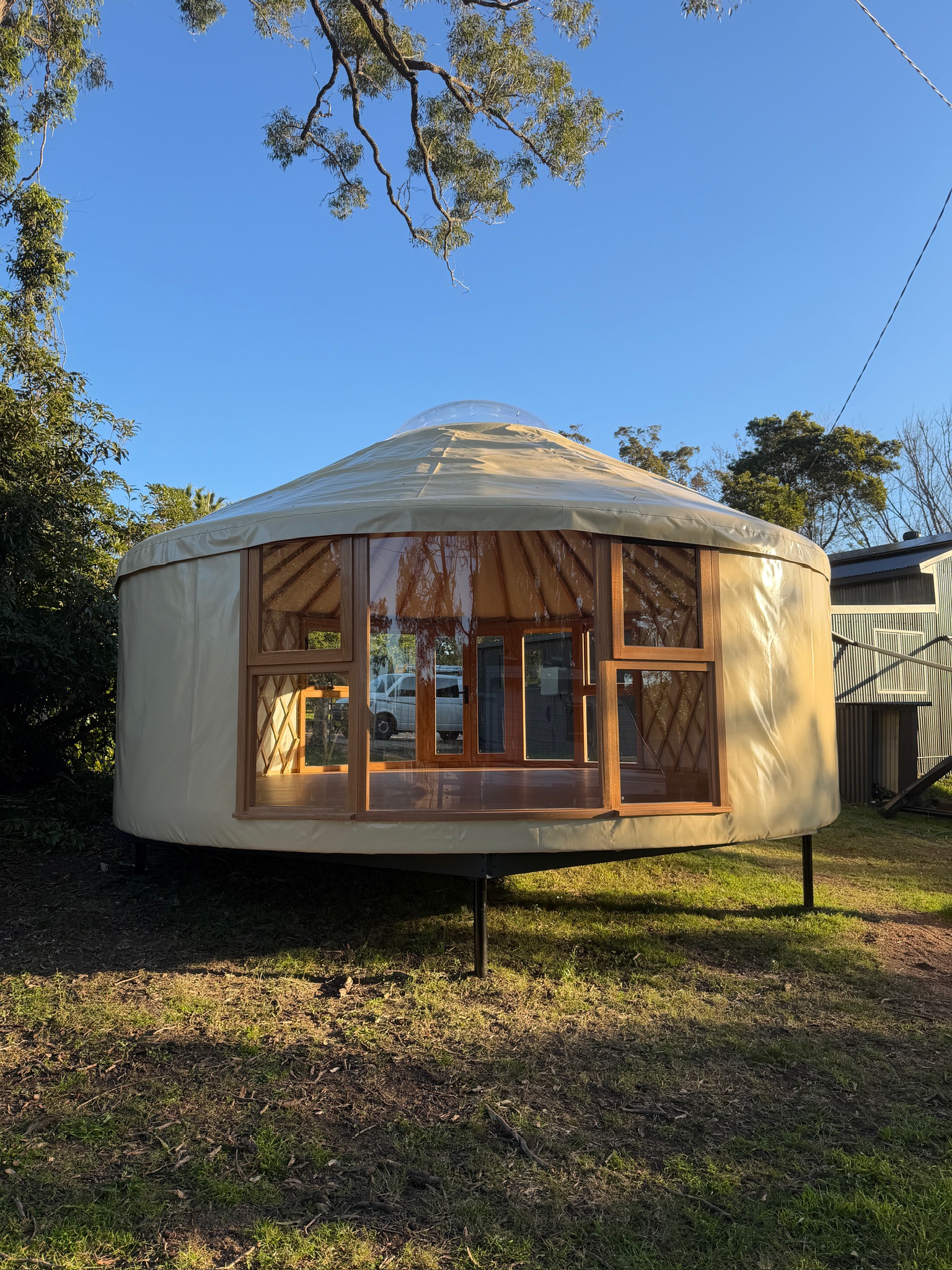 Near-panoramic windows wrapping the yurt exterior