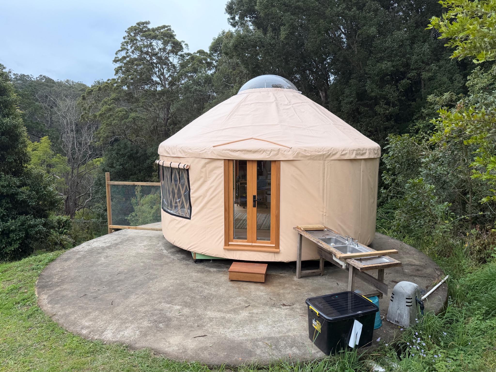 5m yurt exterior settled into the landscape
